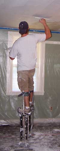 Troweling plaster during resurfacing a ceiling. Avalanche Plastering